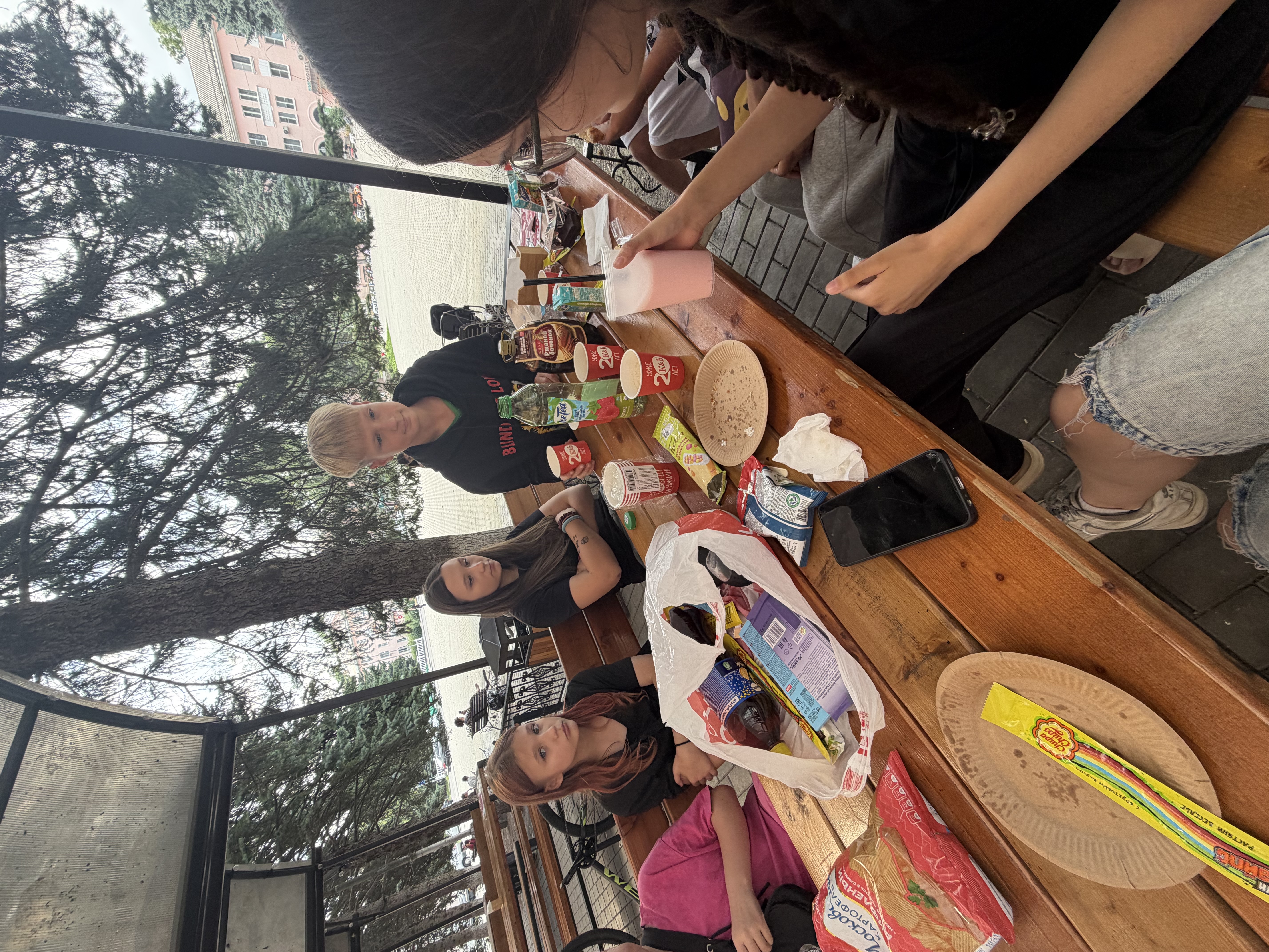 Friends sharing food and drinks at an outdoor table